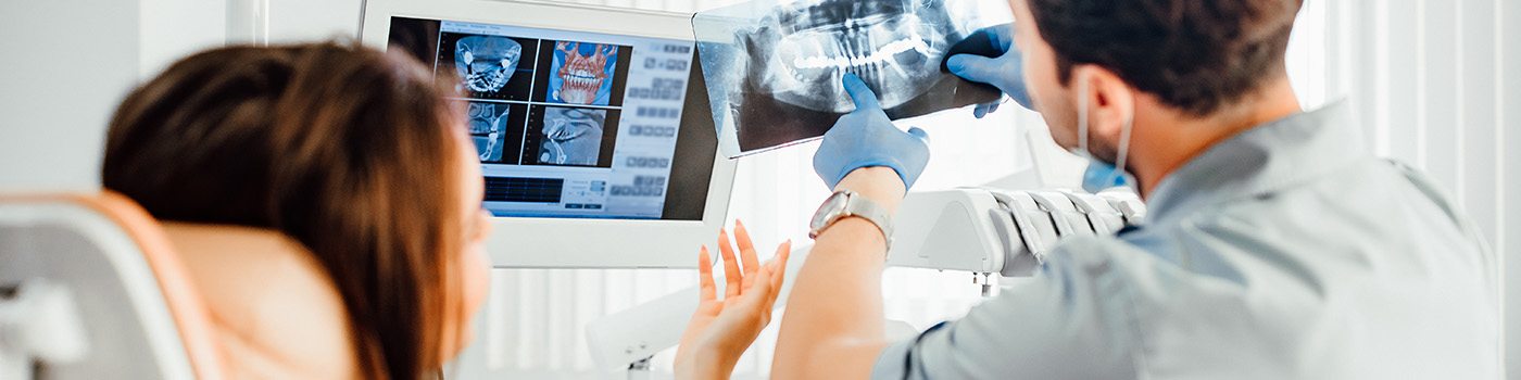 Dentist showing patient the results of her X-rays