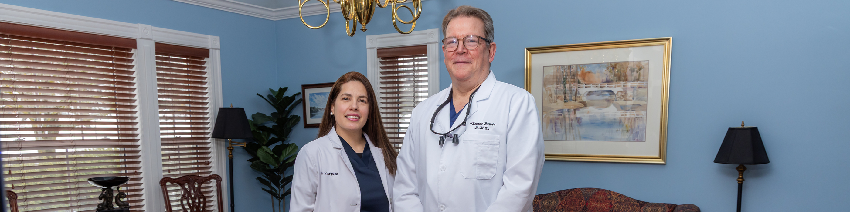 Female dental patient having teeth examined with dental mirror